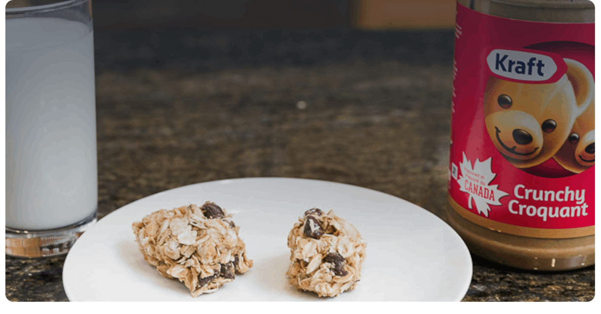 Peanut butter snack bites on a plate beside a jar of Kraft peanut butter