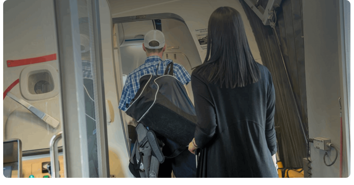 Passengers board an airplane through its door