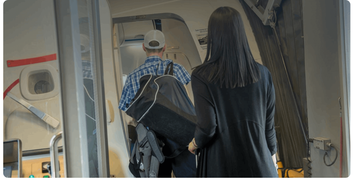 Passengers board an airplane through its door