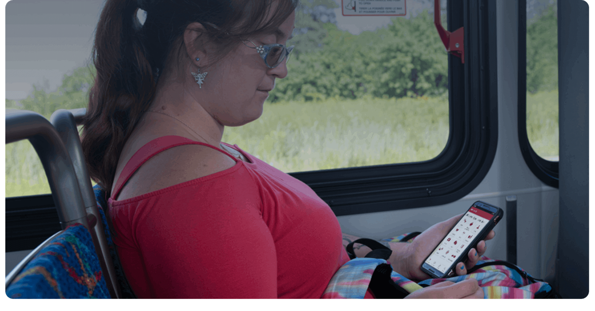 A rider on a Brampton Transit bus looks at a phone