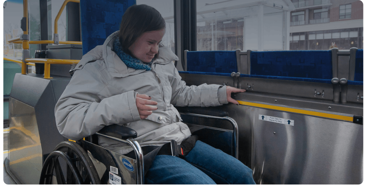 A rider in a wheelchair in the accessible seating area of a Burlington Transit bus