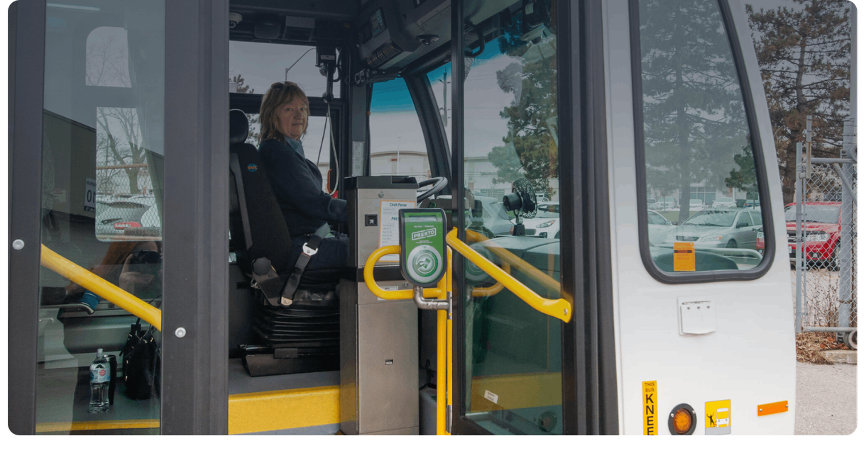 The open front door of a Burlington Transit bus, with the driver inside