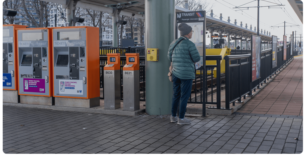 A rider reads the information sign beside the light rail ticket machines