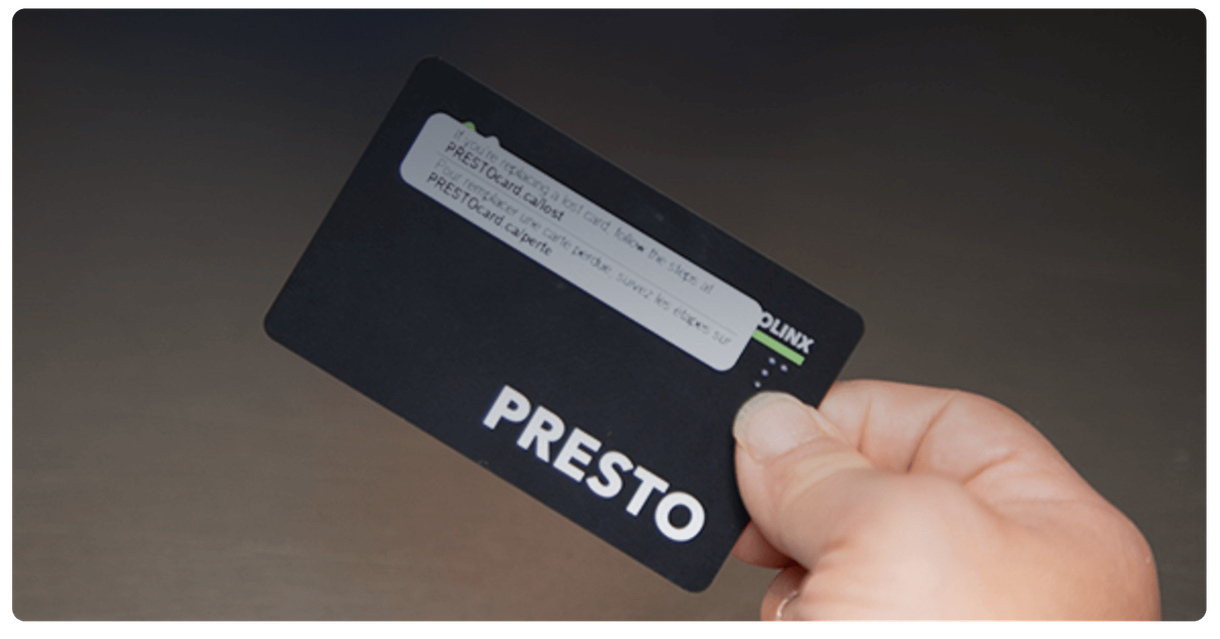 A hand holding a PRESTO card