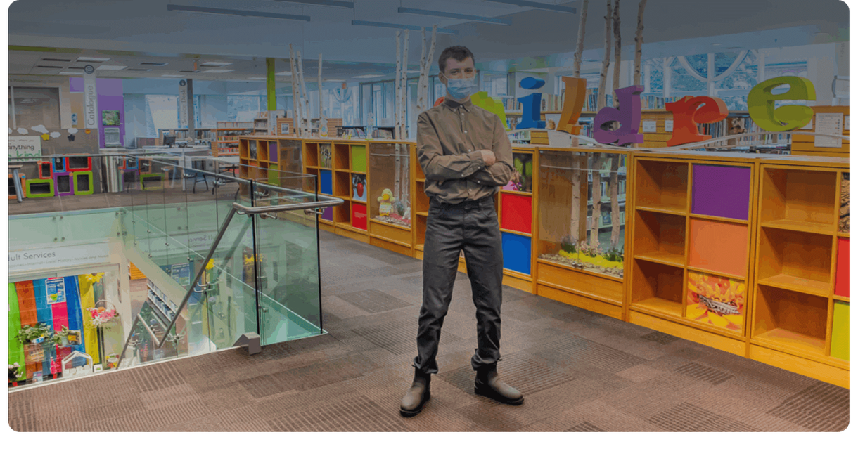 A visitor stands in the children’s area of the library