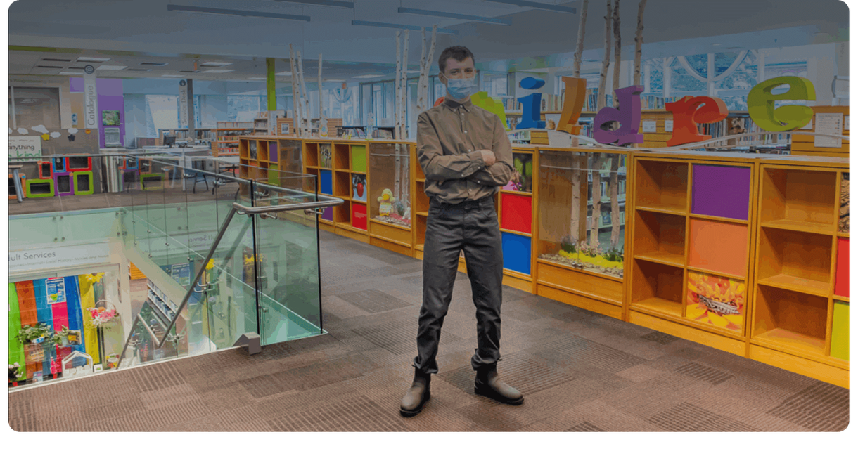 A visitor stands in the children’s area of the library