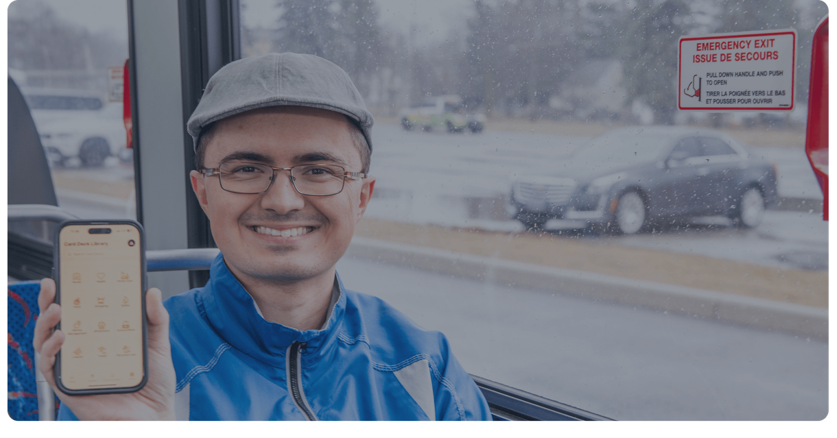 A rider on a bus holds up his phone
