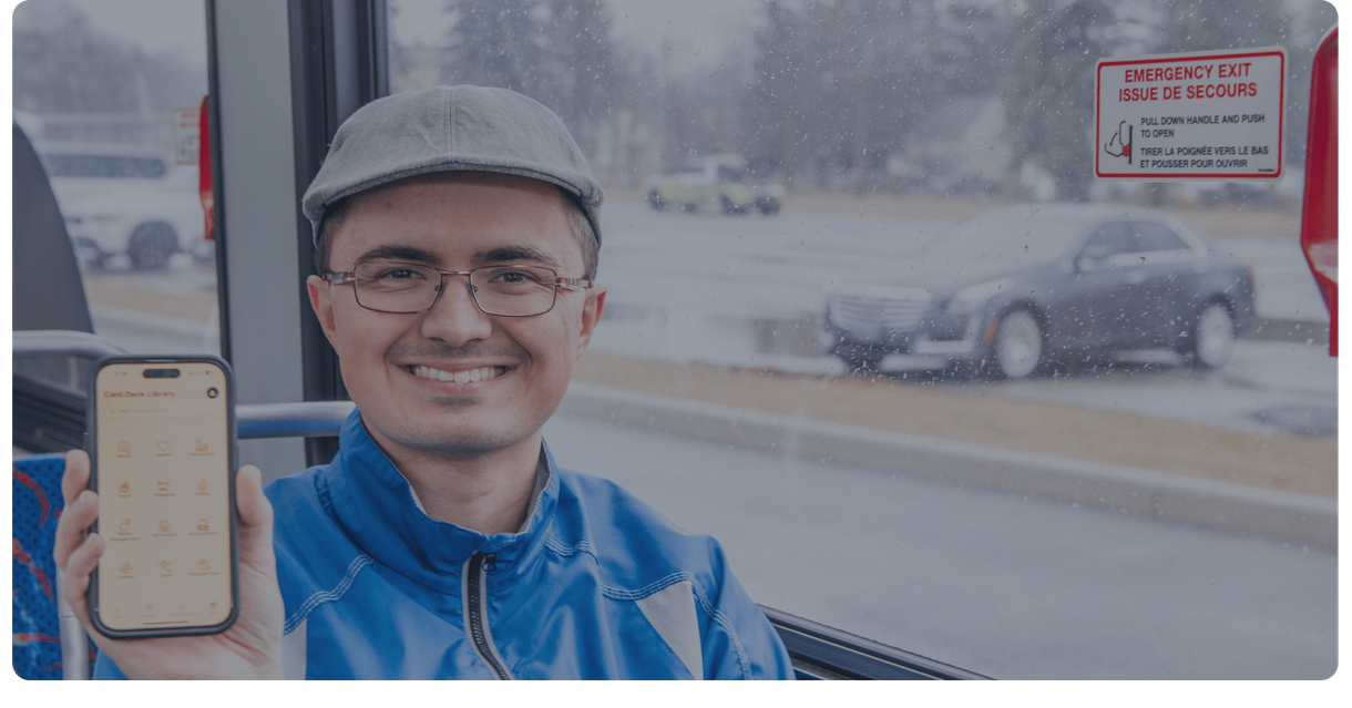 A rider on a bus holds up his phone