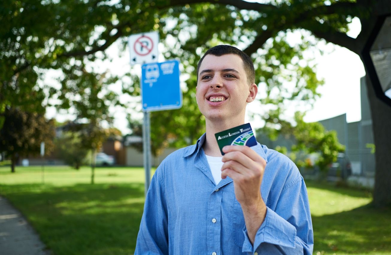 Happy young man waiting for the bus