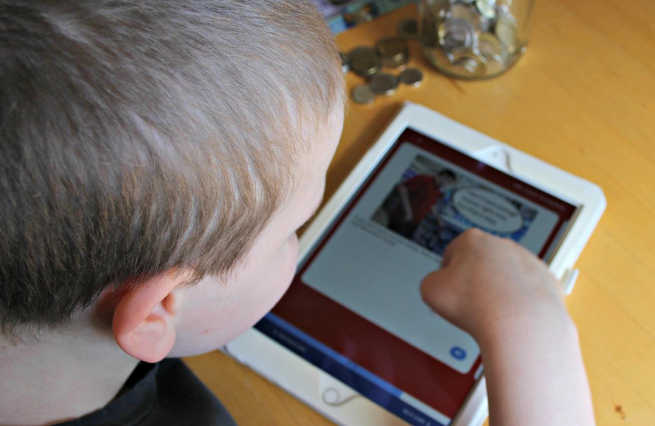 Child viewing the MagnusCards app in an iPad