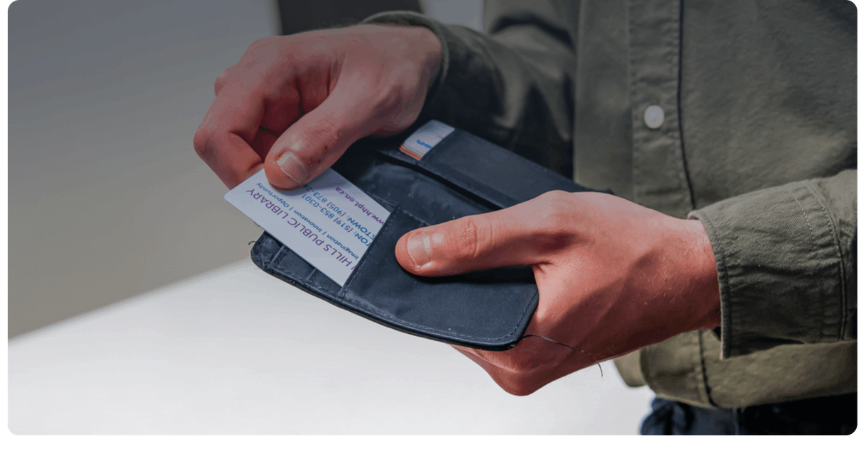 A Halton Hills Public Library card held over a wallet