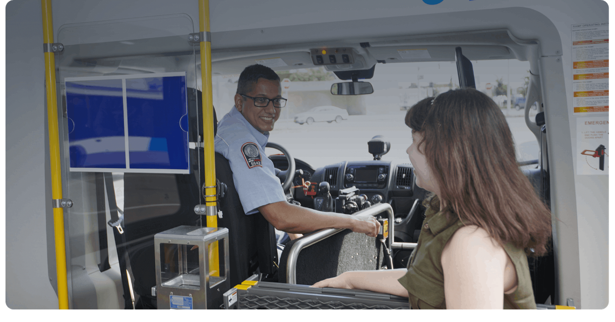 A rider talks with the driver while boarding an NFTA Metro paratransit van