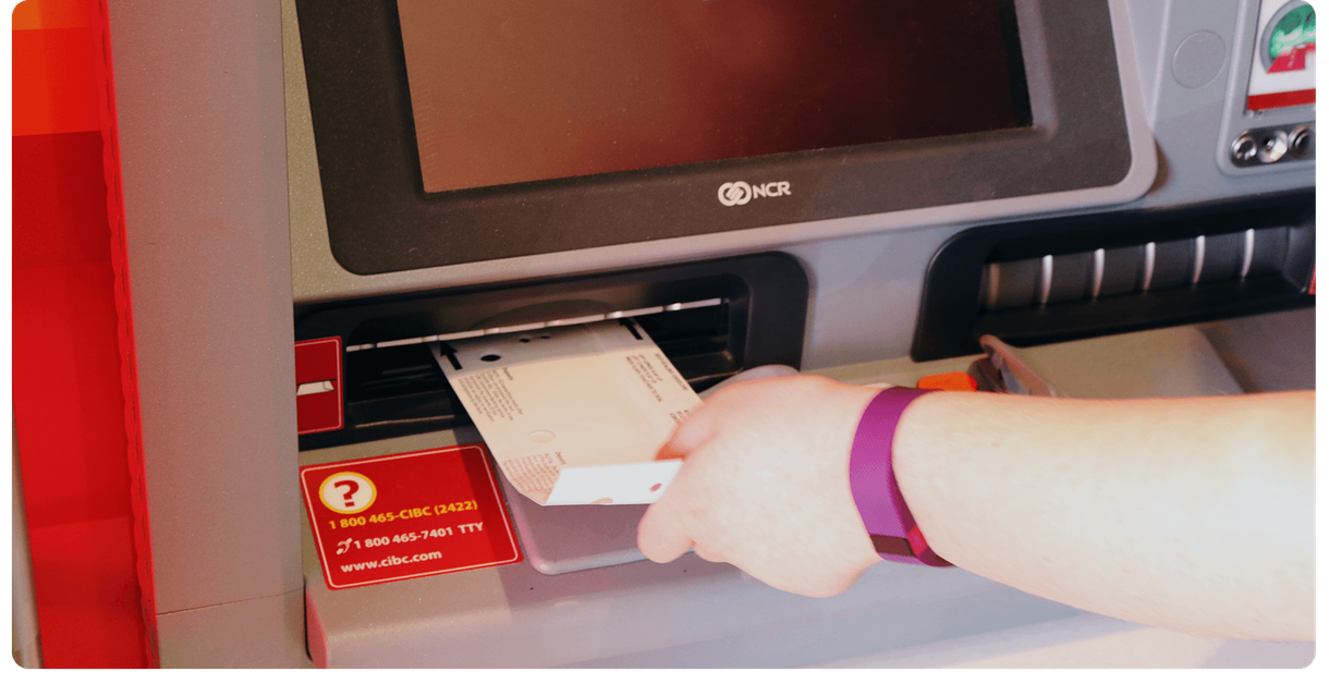 A customer puts a cheque into a CIBC ATM