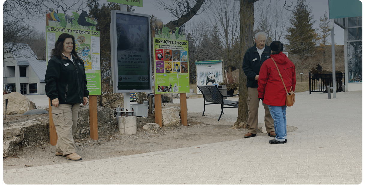 Toronto Zoo staff greet visitors near the welcome signs
