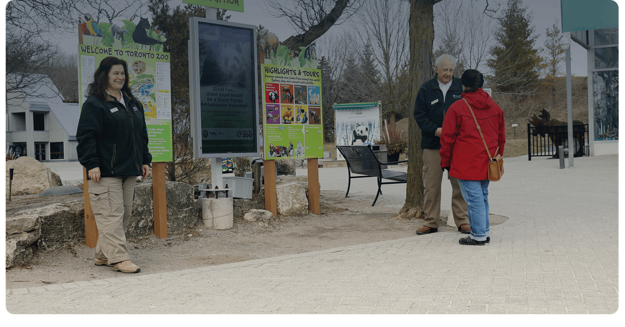 Toronto Zoo staff greet visitors near the welcome signs