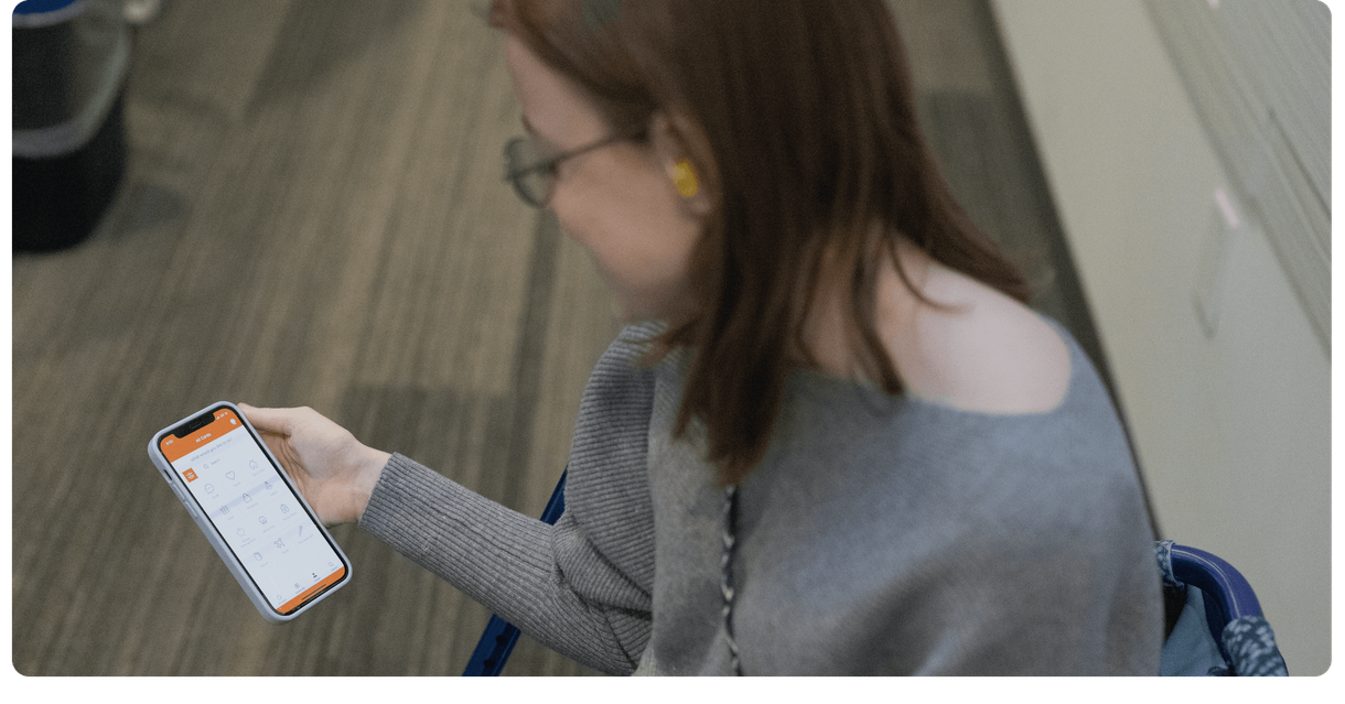 A customer looks at the MagnusCards app on her phone