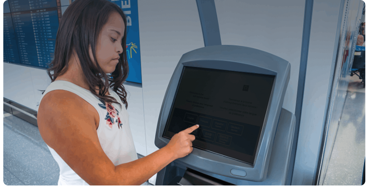 A traveller uses a check-in kiosk at Toronto Pearson