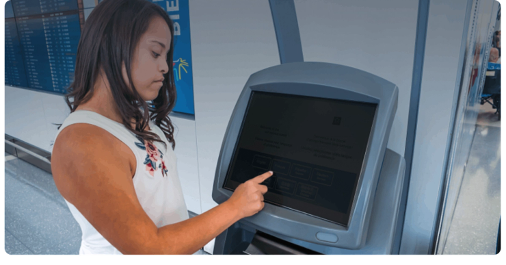 A traveller uses a check-in kiosk at Toronto Pearson