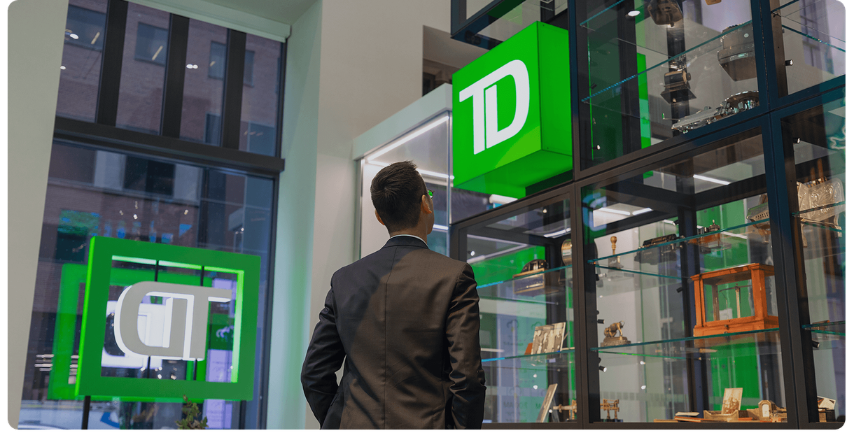 A customer inside a TD branch under the green TD sign