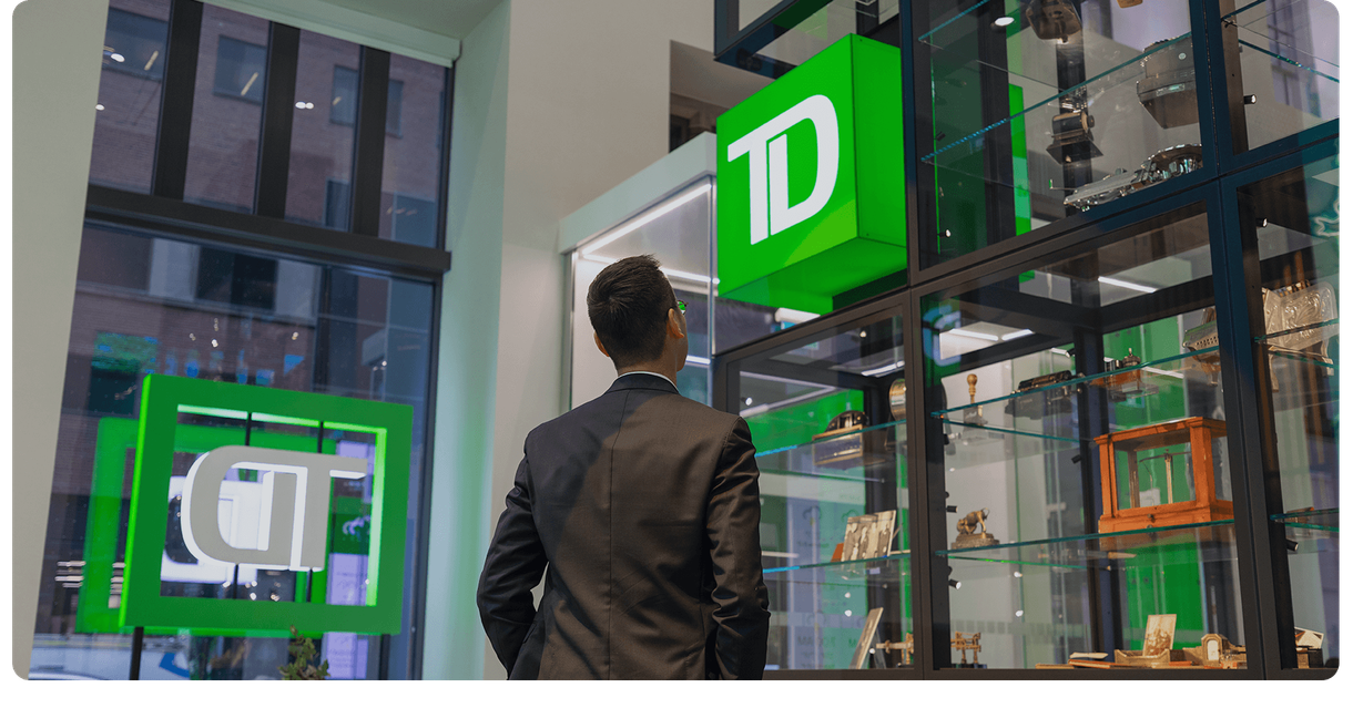 A customer inside a TD branch under the green TD sign