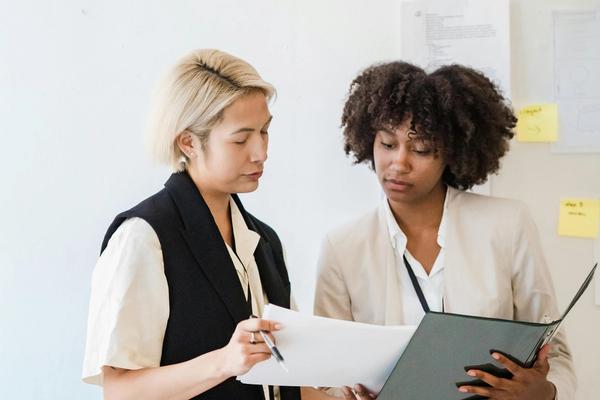 Two housing officers reviewing a case file together