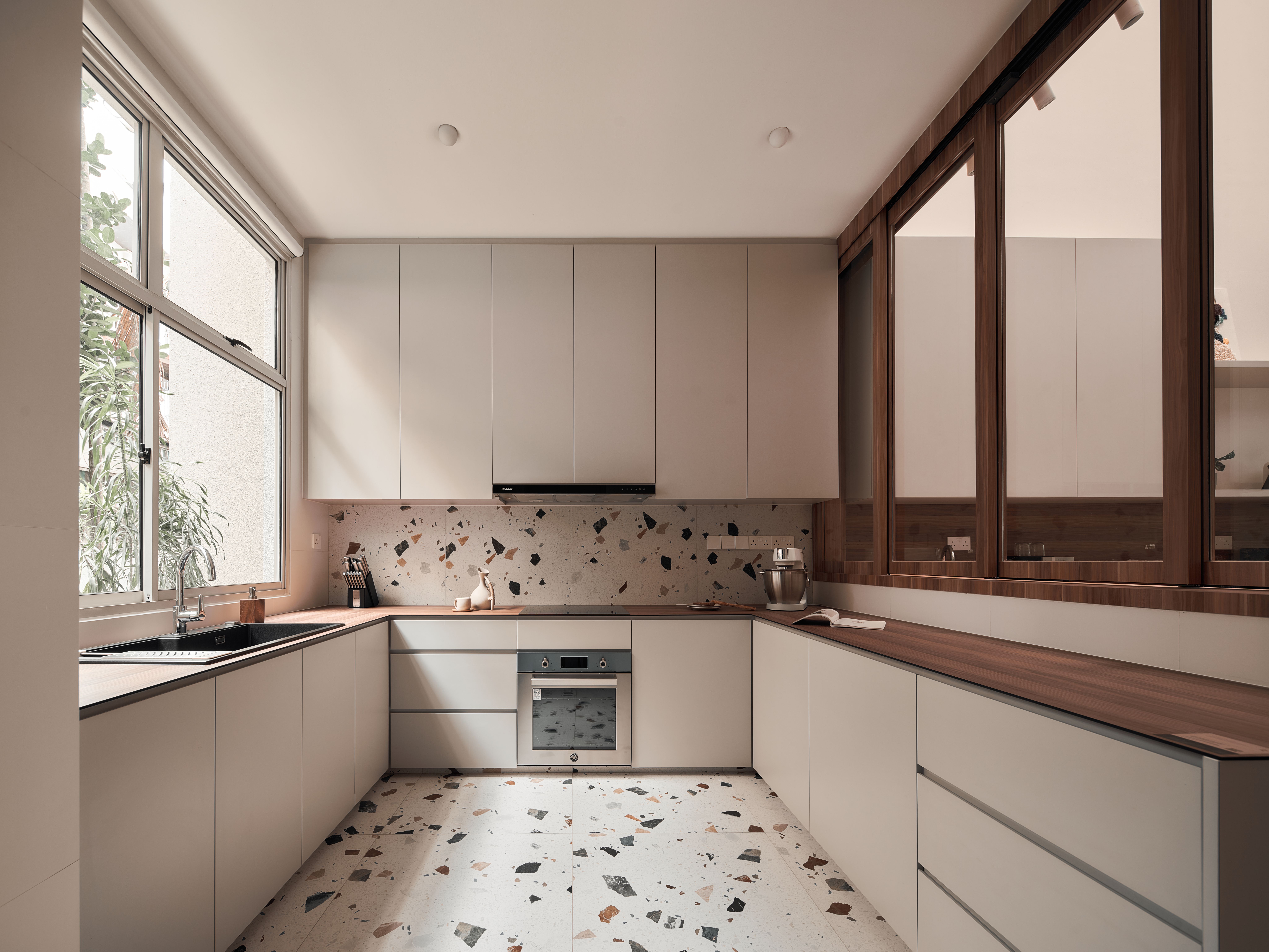 Spacious kitchen featuring a stainless steel oven, sink, and Terrazzo Tiles flooring
