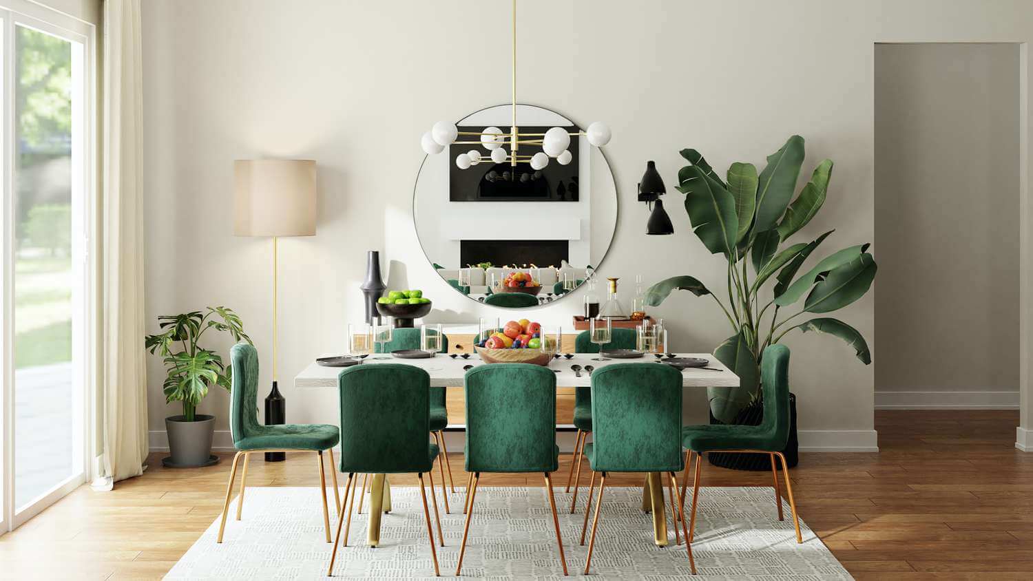 Dining area with a large round mirror and green velvet chairs, enhancing light and creating an expansive feel.