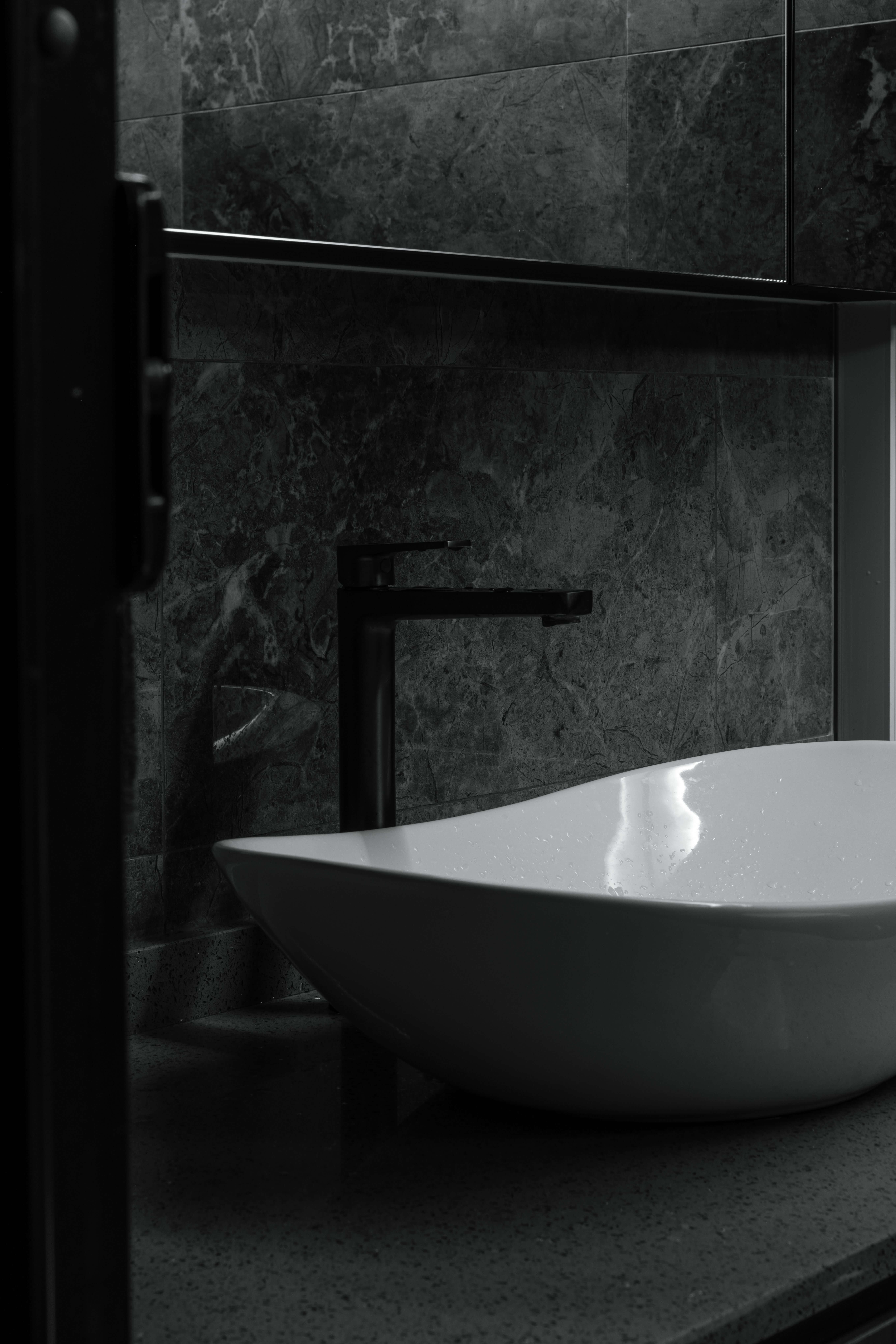 Minimalist black and white bathroom with a sleek porcelain sink