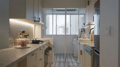 Kitchen leading to the laundry room separated by white framed glass doors