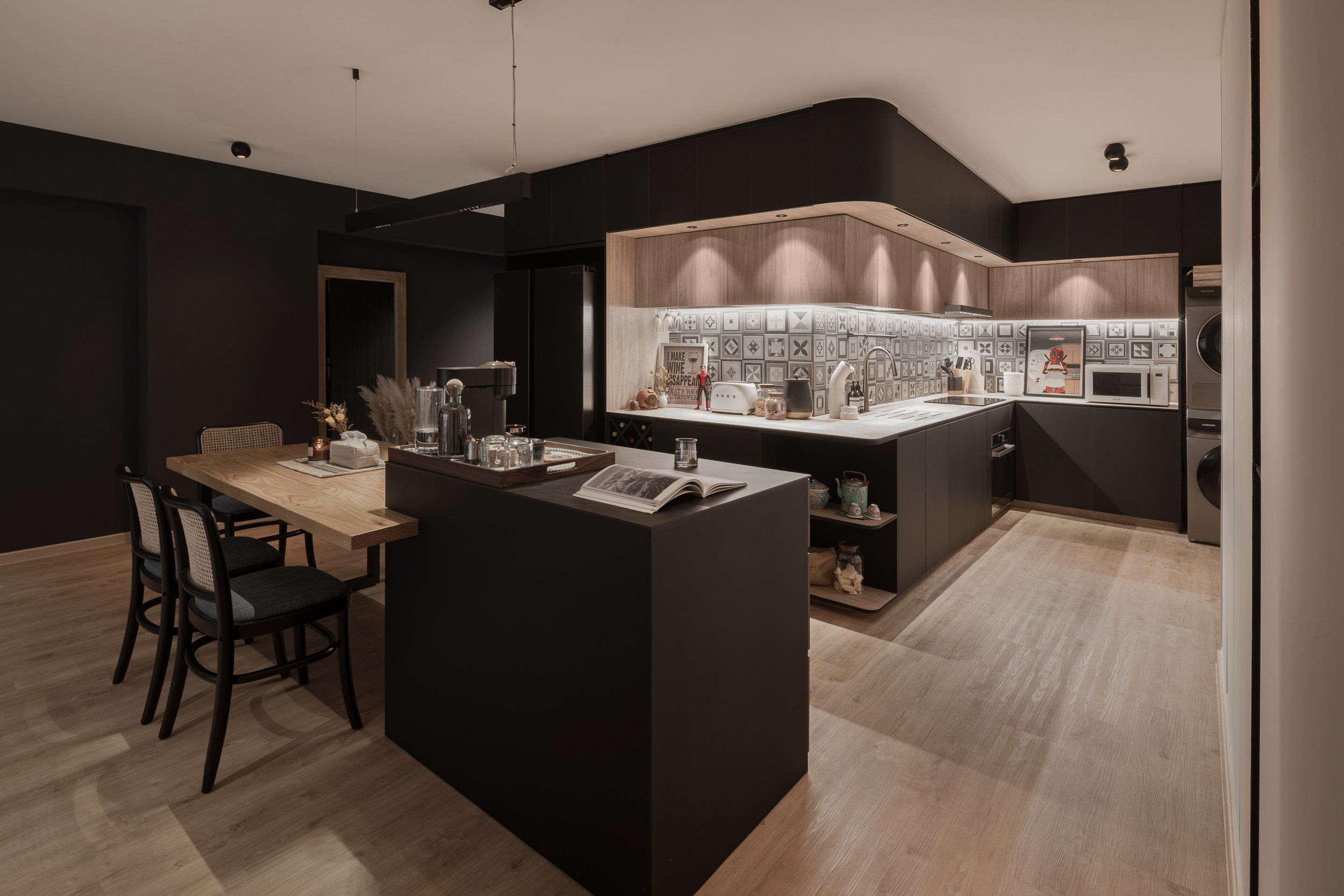 A modern kitchen with dark cabinetry, wooden countertops, and ambient lighting, blending modern aesthetics with subtle vintage touches.