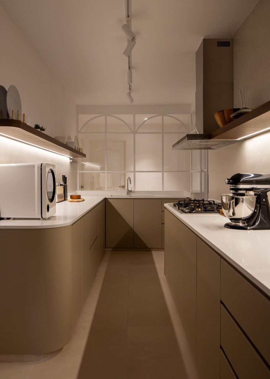 Contemporary kitchen with light-colored cabinets, open shelving, and a minimalist design, created by Sumspace.