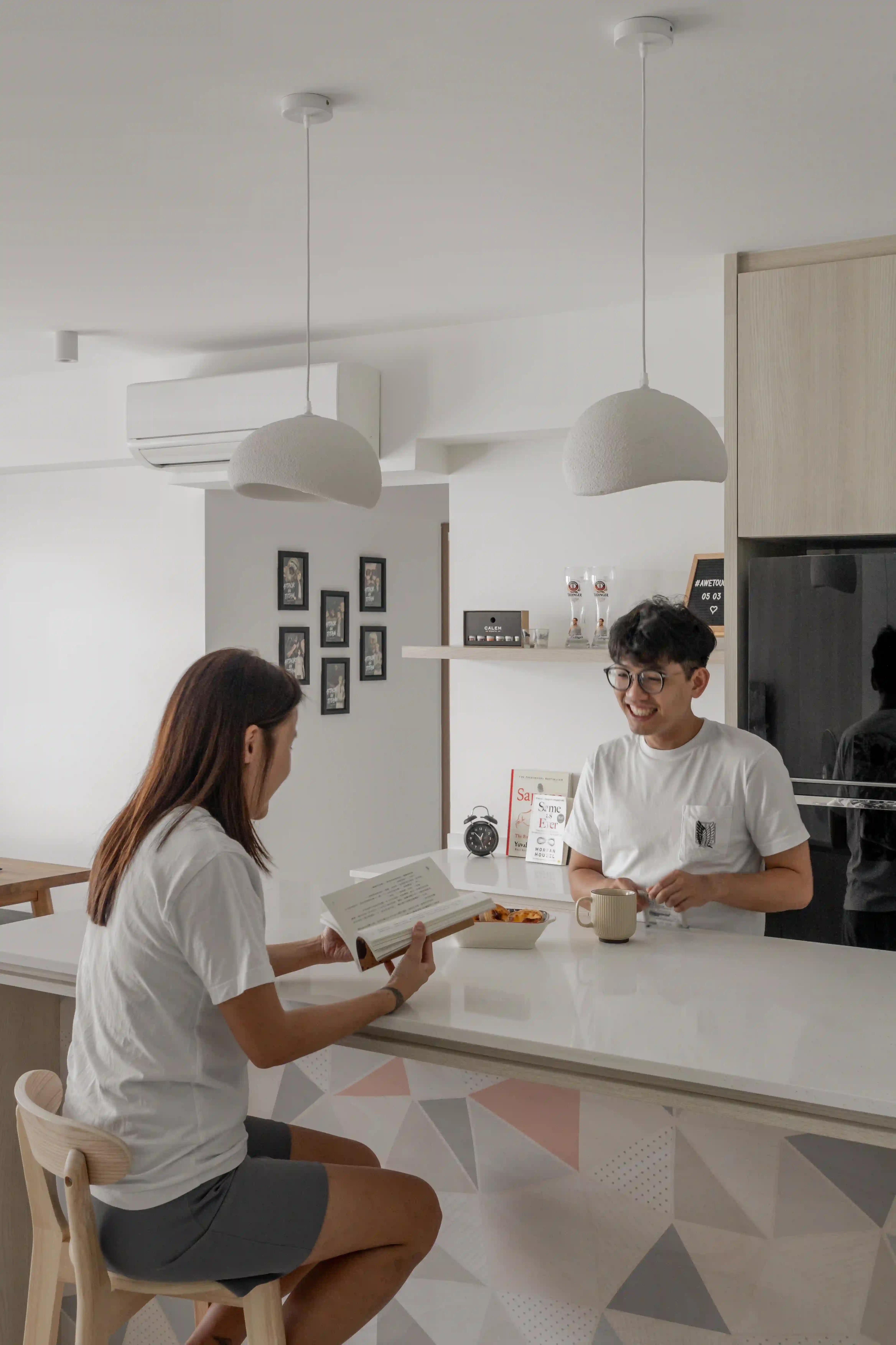 bright hdb kitchen with white pendants, a breakfast bar and pastel tiles; interior decor singapore that invites everyday connection