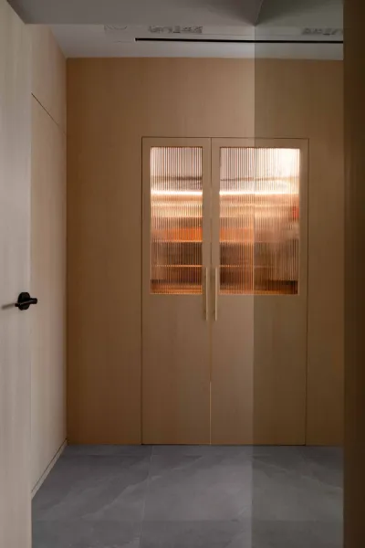 Entrance featuring seamless wooden doors and walls with grey flooring