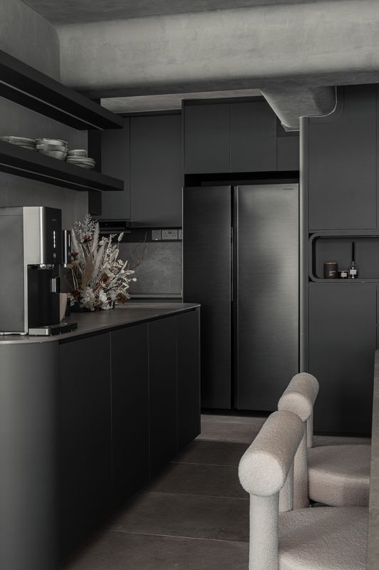 Modern minimalist kitchen with black cabinets and simple grey countertops