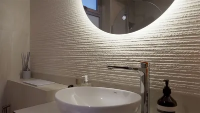 Monochrome cream sink area with led mirror on textured wall