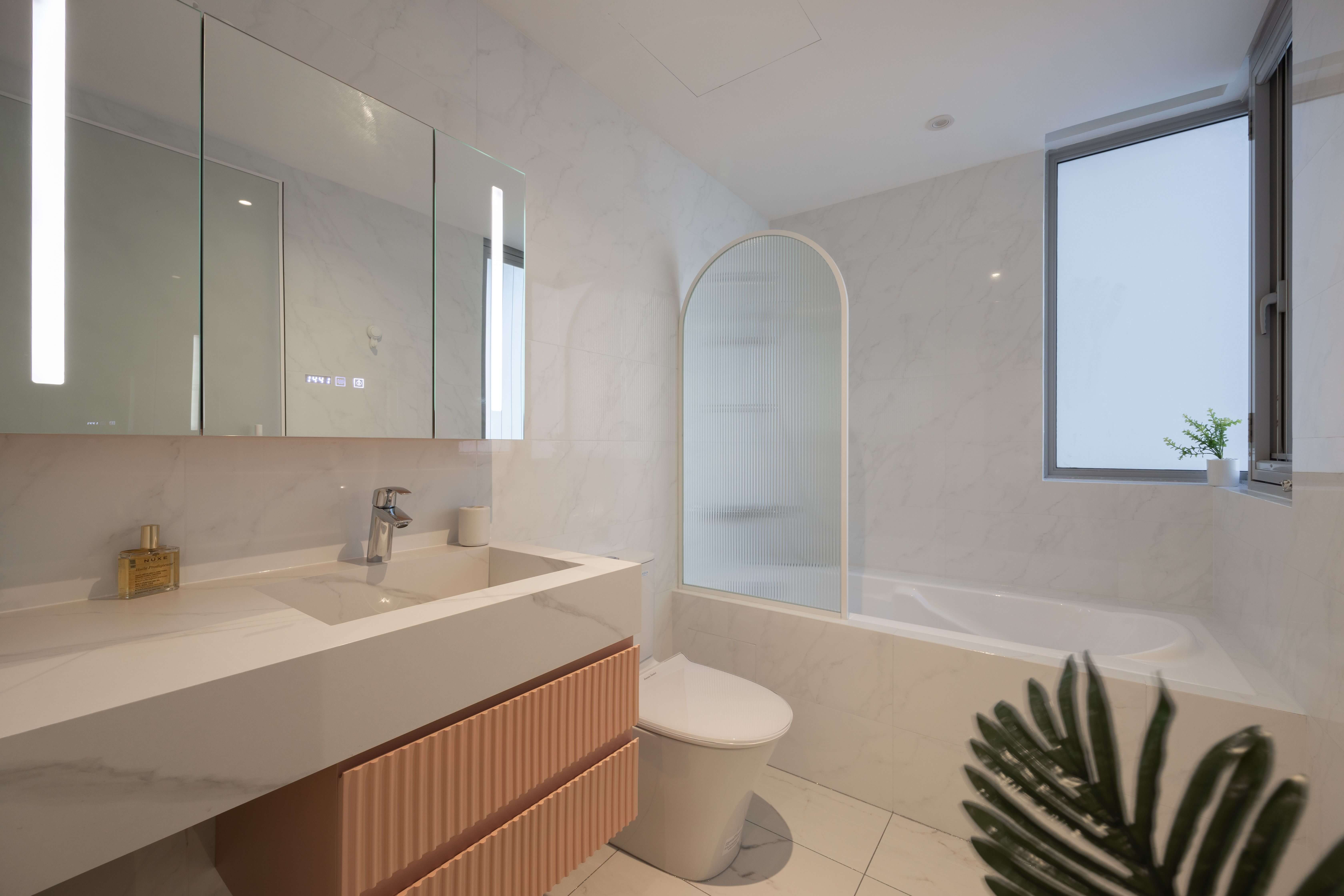 Spacious white bathroom with a central bathtub