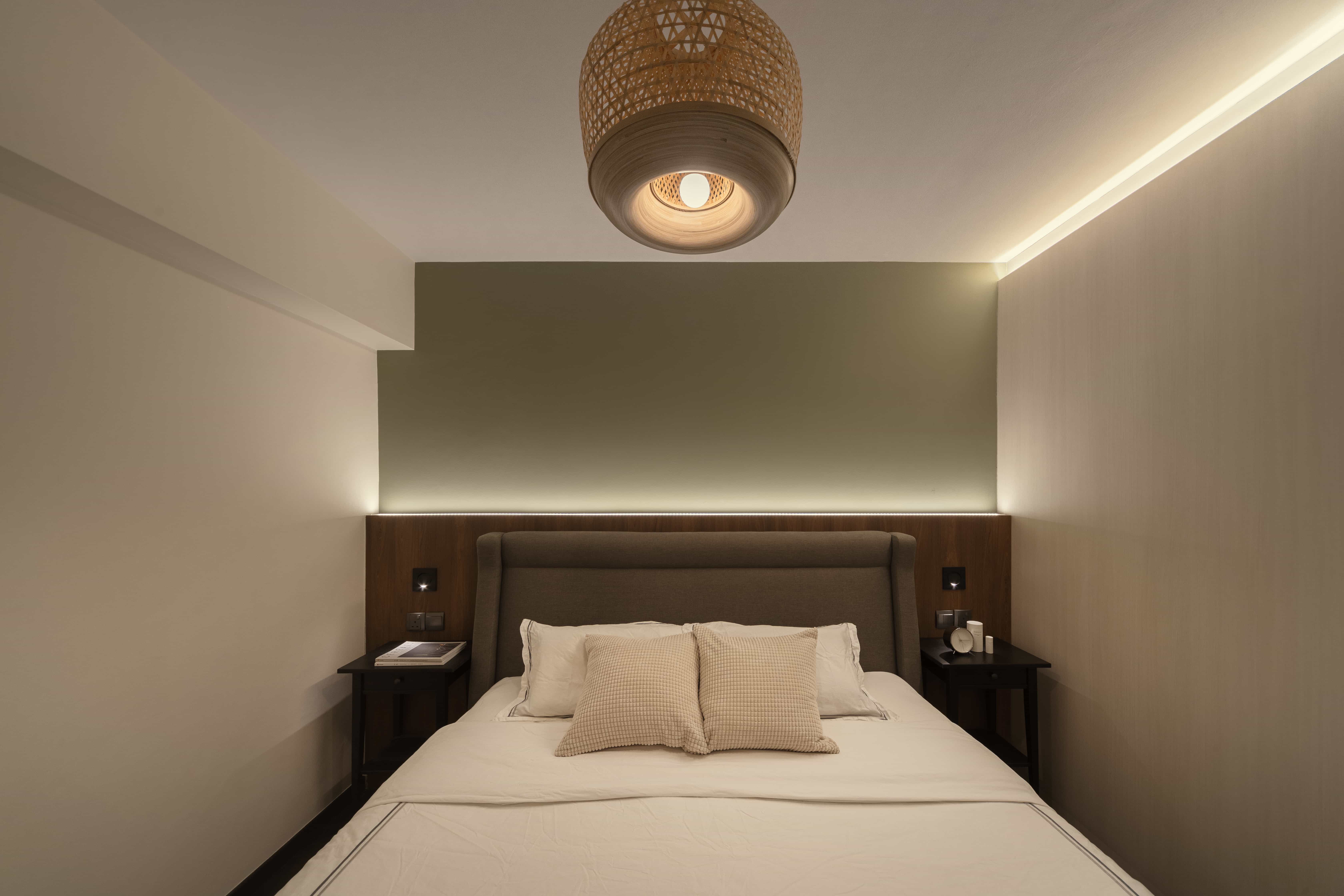 Modern guest bedroom with a cozy bed, ambient lighting, and elegant decor.