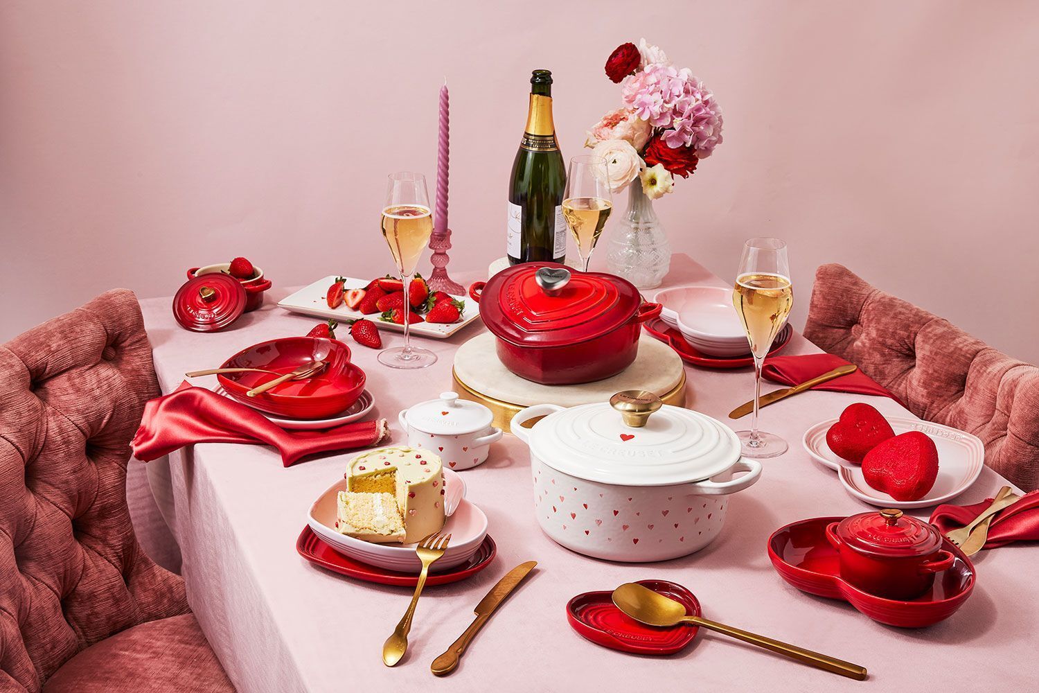 Romantic Valentine’s Day home dining setup with heart-themed cookware and sweet treats.