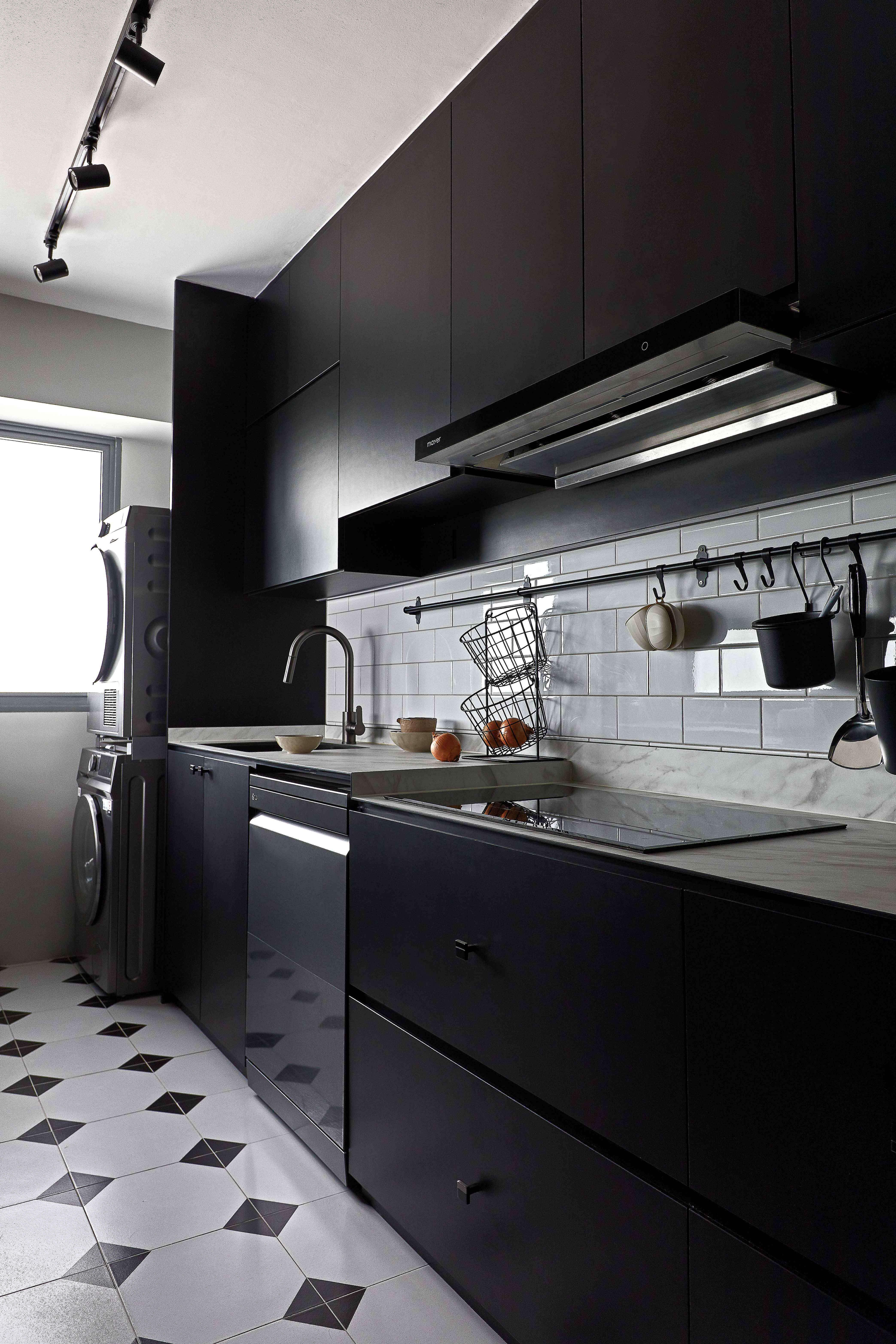 HDB kitchen with dark cabinets and wall-mounted storage solutions for cookware.