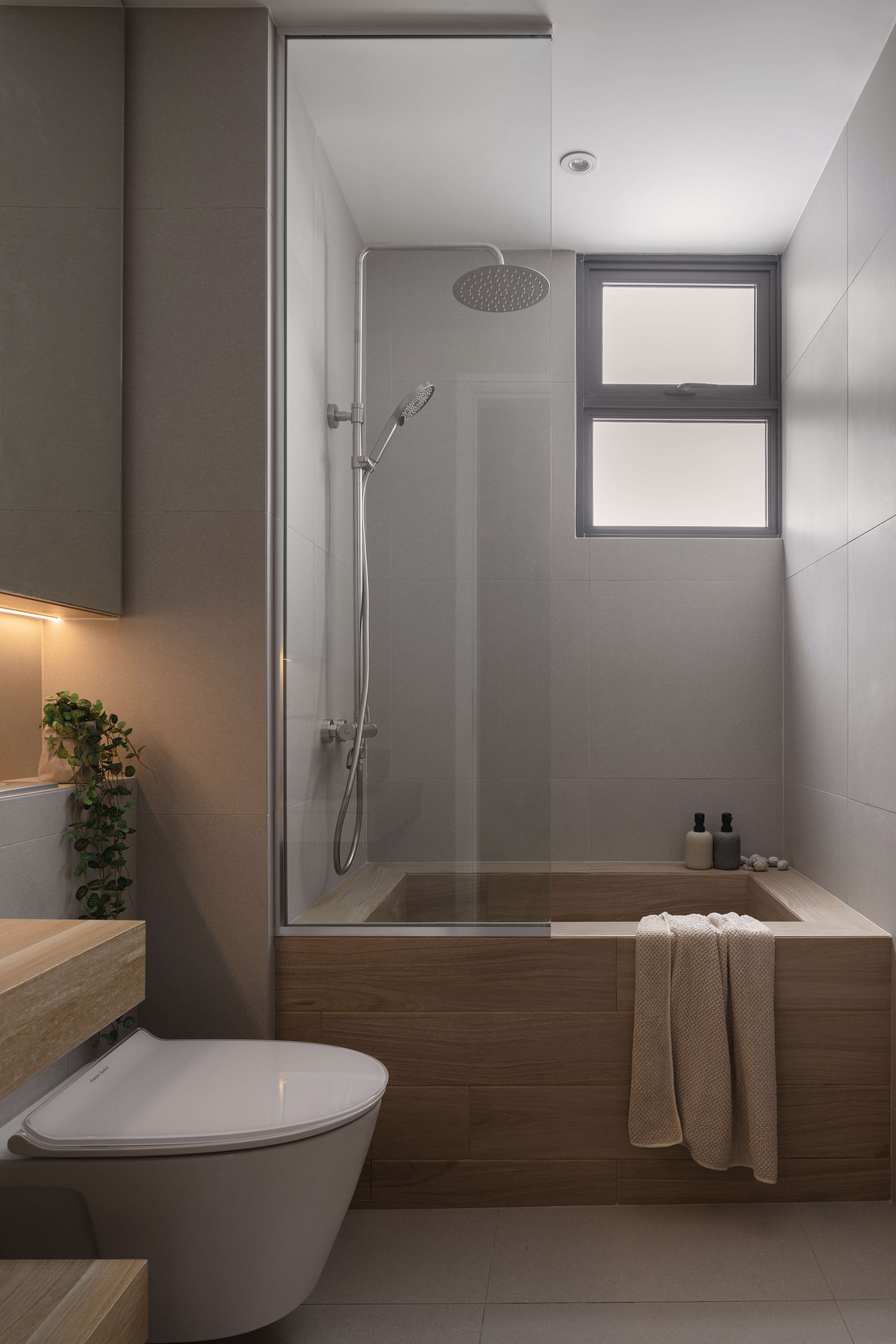 Contemporary bathroom featuring a walk-in shower with a rain showerhead and a built-in wooden bathtub.