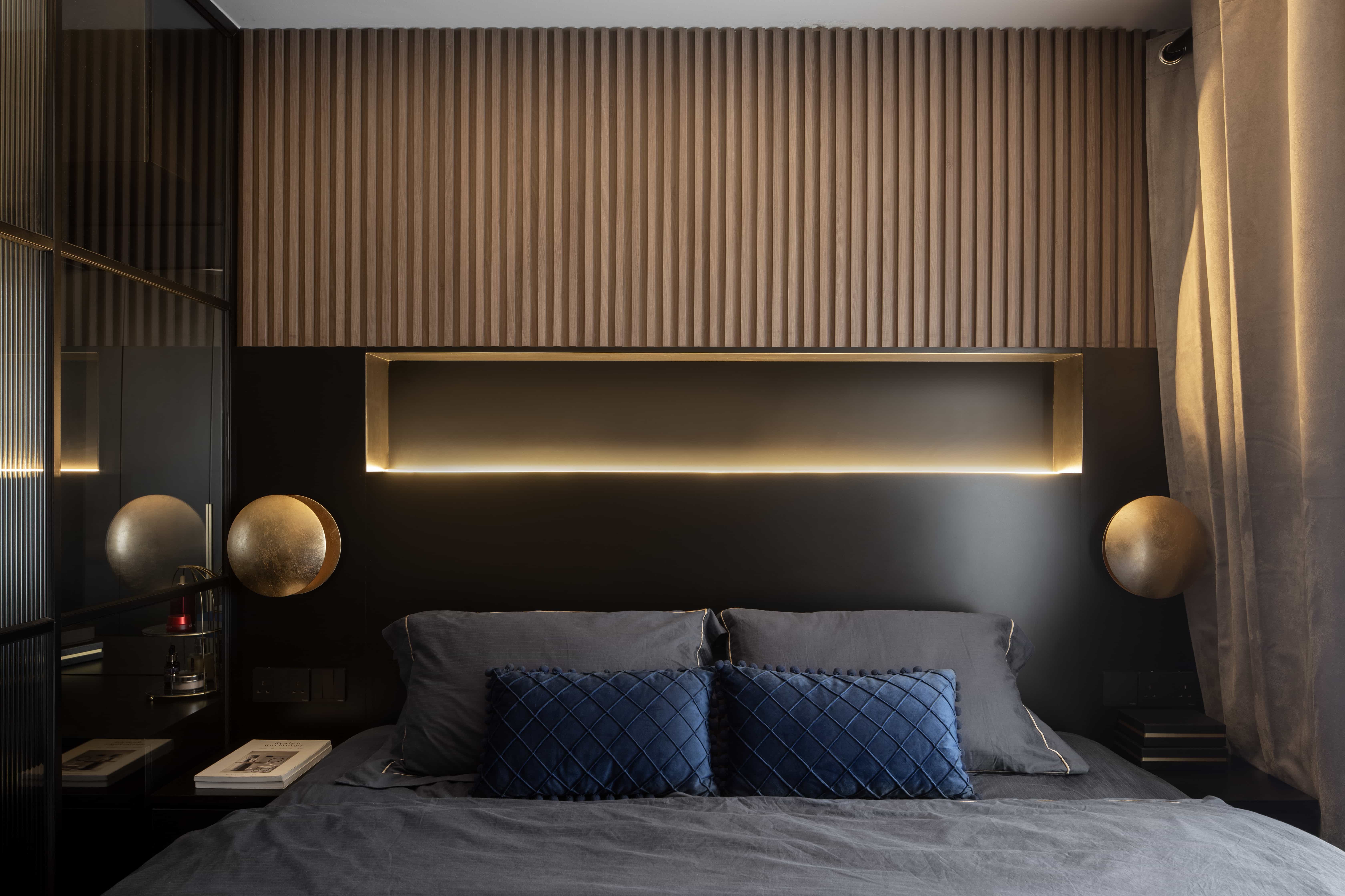 Luxury modern bedroom with custom fluted wall design and sophisticated lighting.