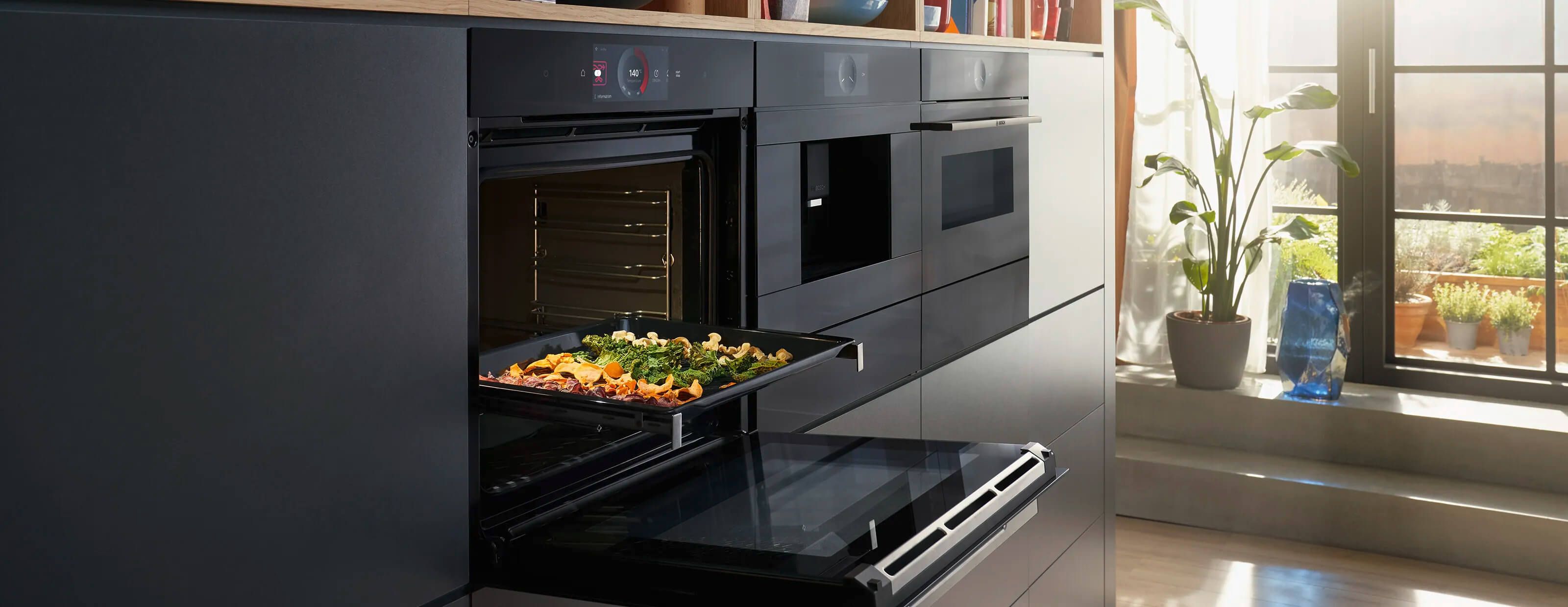 Bosch Series 8 smart oven in an apartment with a healthy vegetable dish, showcasing innovative cooking technology in a stylish home environment