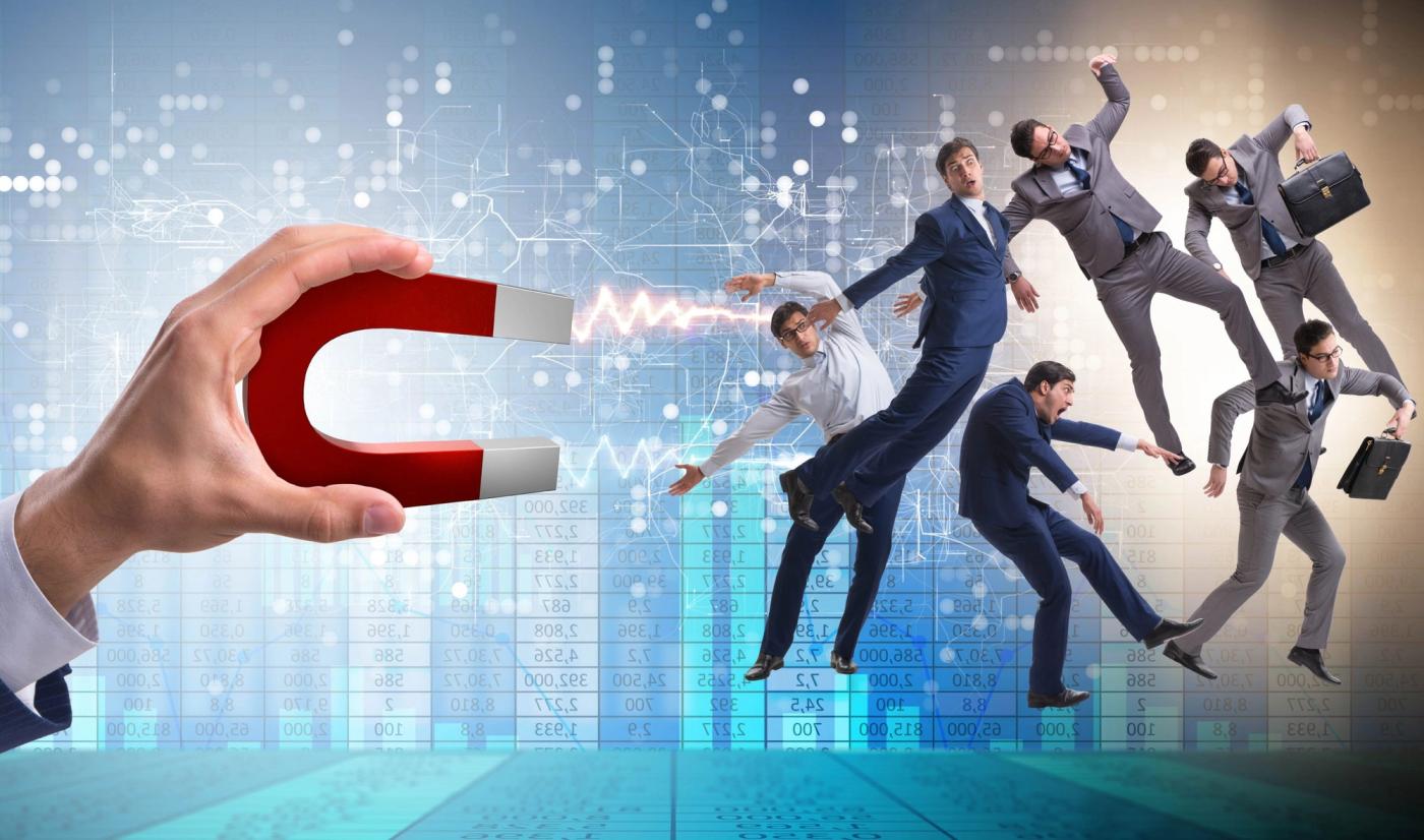 Businessman in recruitment concept with horseshoe magnet