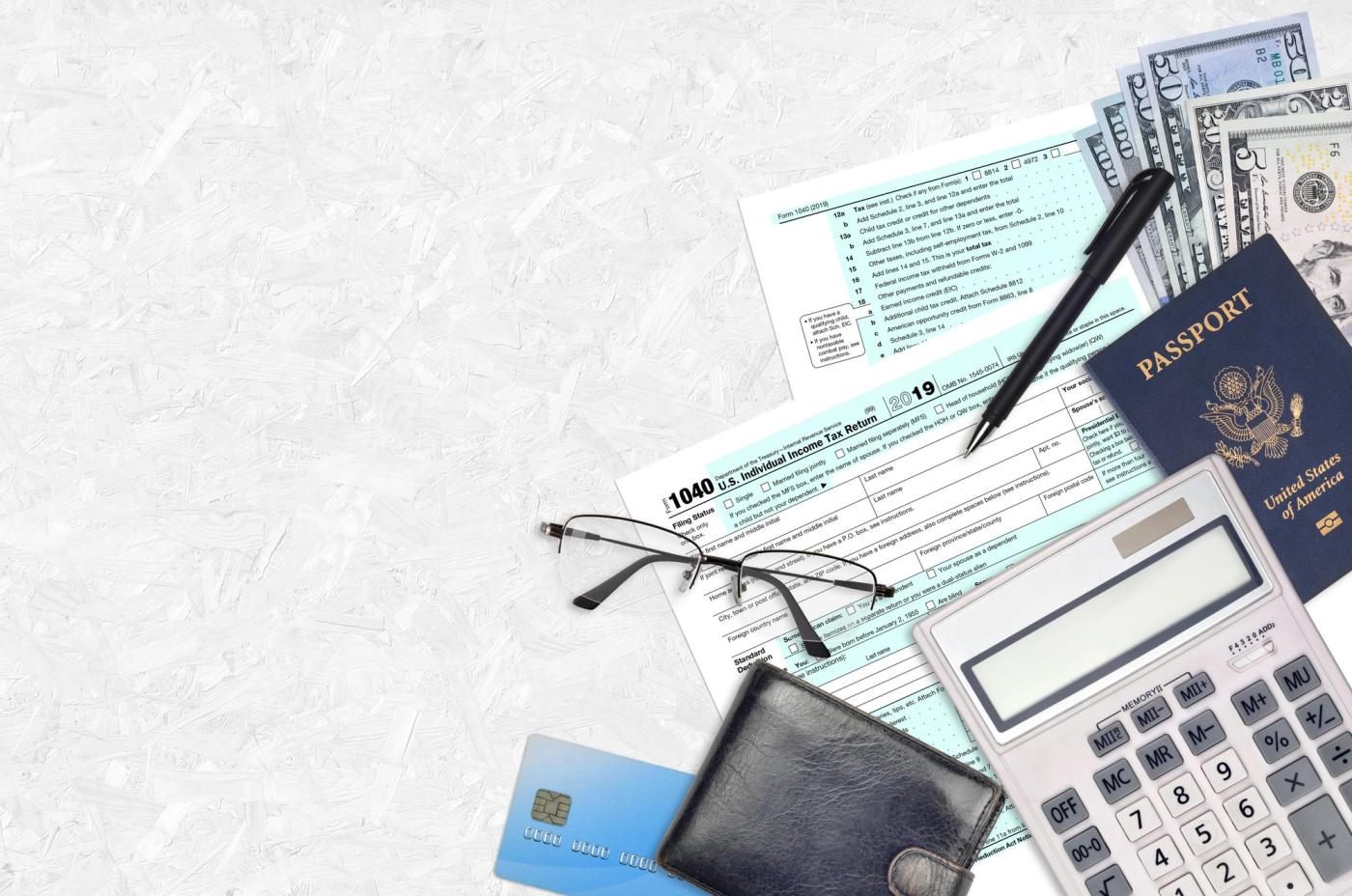 IRS form 1040 Individual income tax return lies on flat lay office table and ready to fill. U.S. Internal revenue services paperwork concept. Time to pay taxes in United States