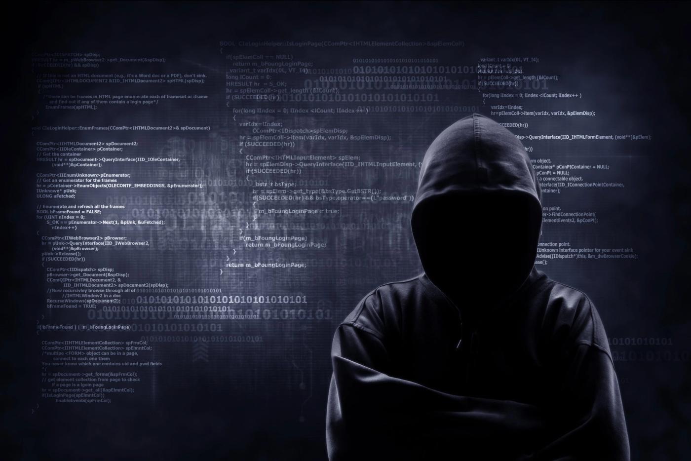 Internet crime concept. Hacker working on a code on dark digital background with digital interface around.