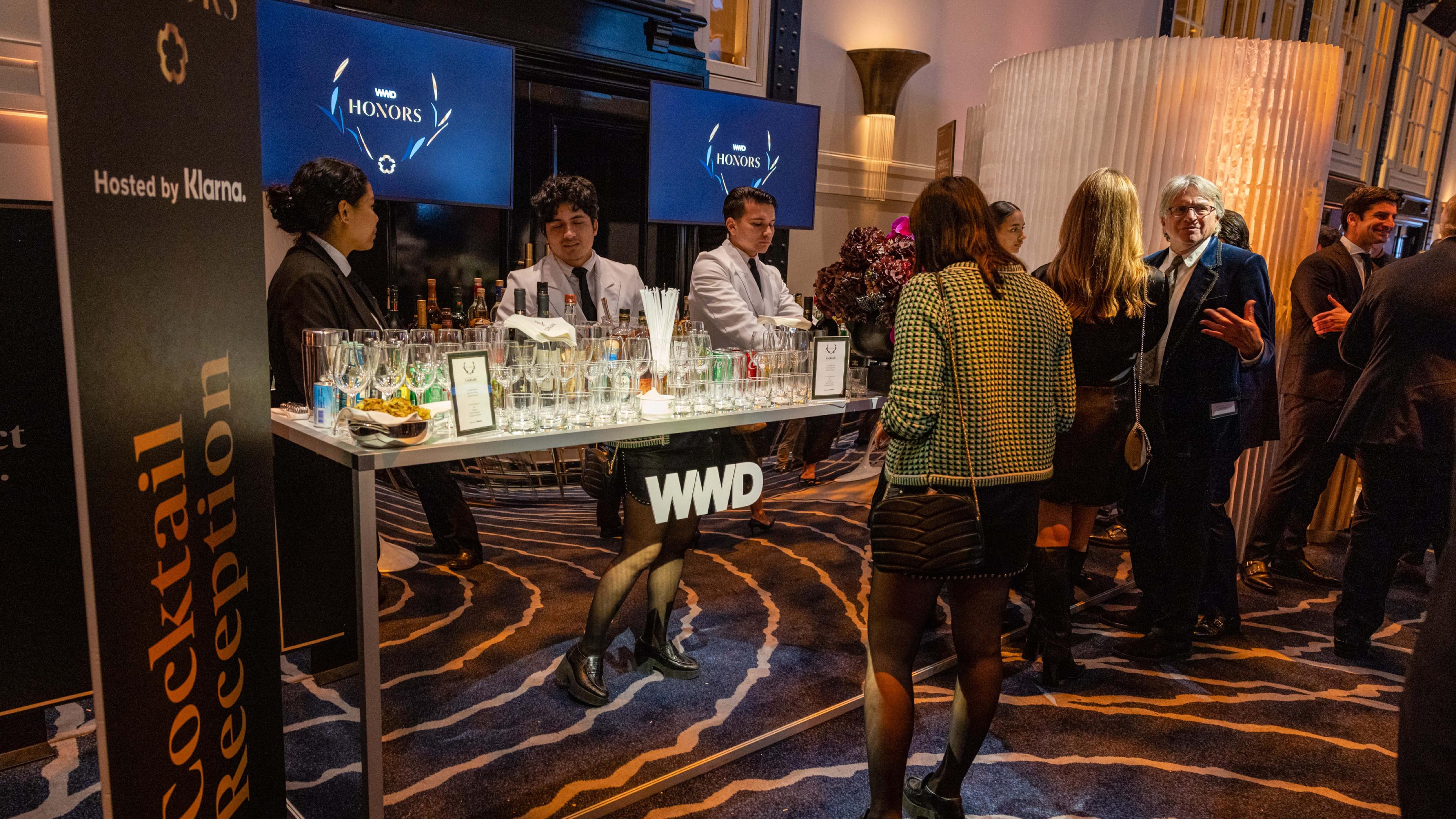Bar at the WWD Honors event with branding on large totem signs
