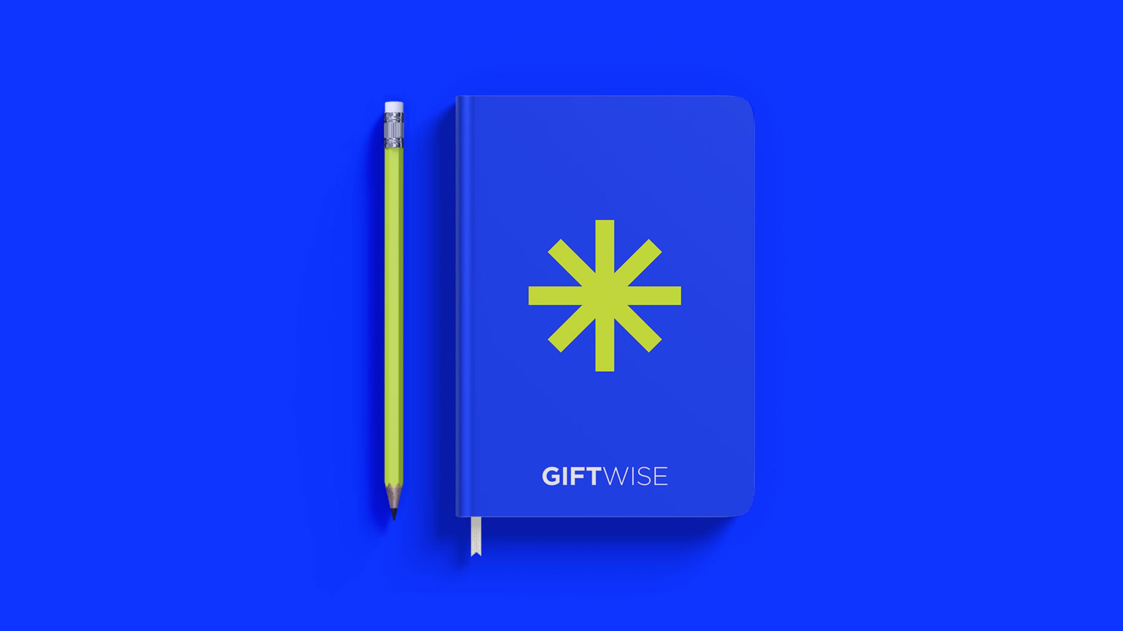 GiftBoard branding and illustrations on a blue notebook with a white pencil on the side