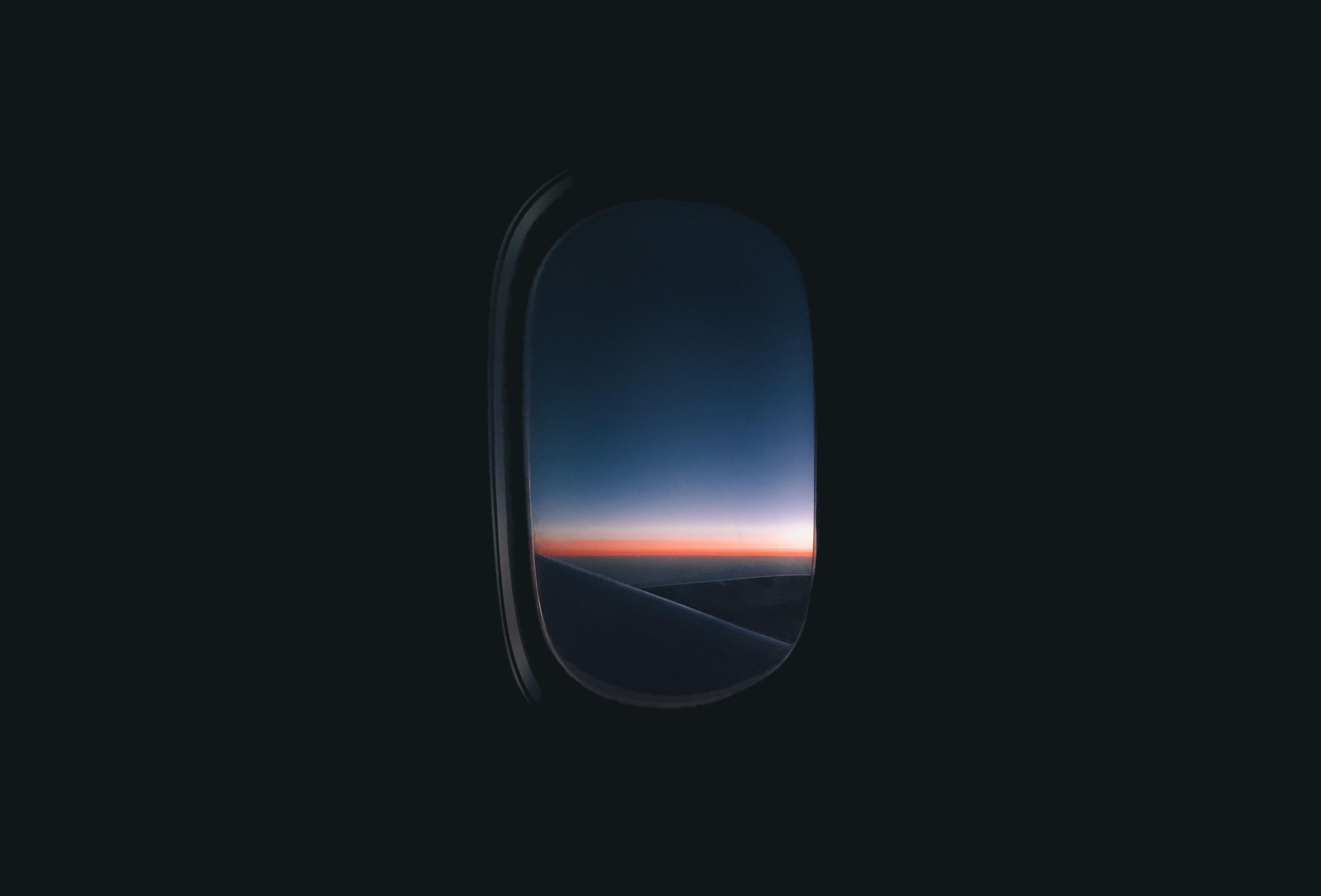 Plane window facing sunrise