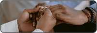 Close-up of two people holding hands in support and comfort