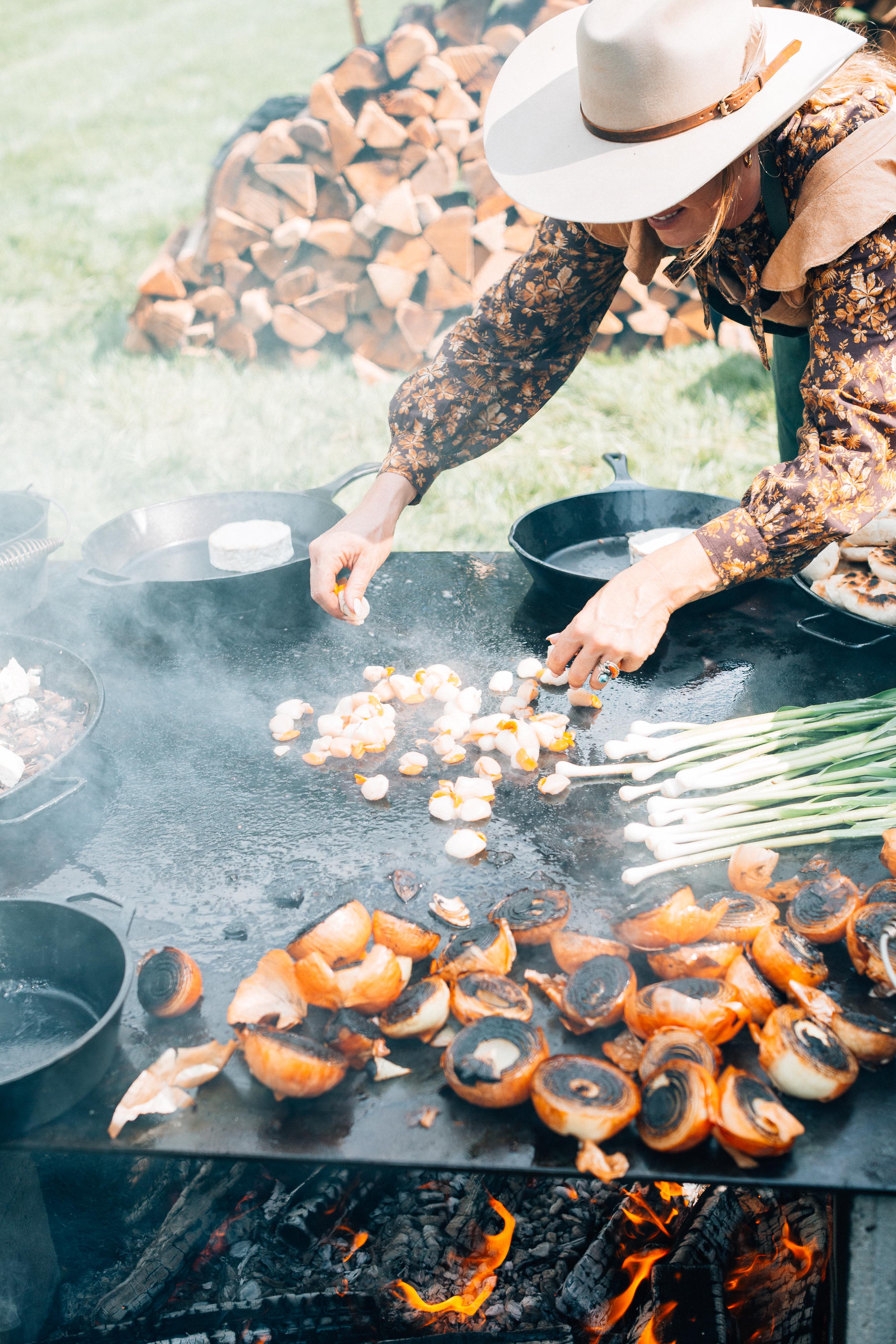 Sarah Glover working with local ingredients prepared on an open fire.